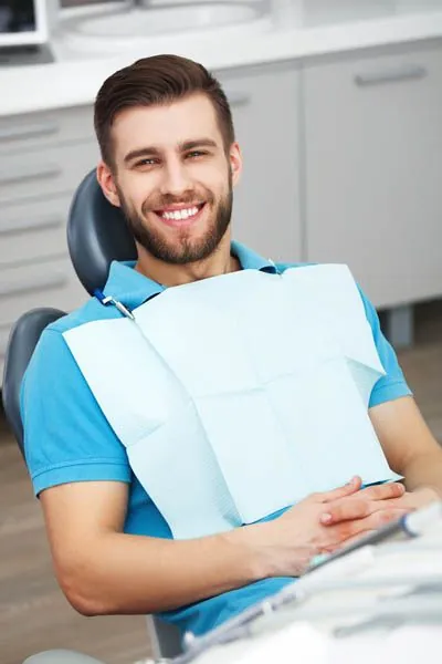 patient smiling after having dental implant placed